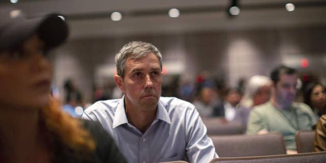 Texas Democrat gubernatorial candidate Beto O'Rourke listens before interrupting a news conference headed by Texas Gov. Greg Abbott in Uvalde, Texas Wednesday, May 25, 2022.