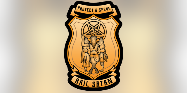 A prototype police badge that TST is sending to Haven, Kansas, that depicts children looking up at an androgynous, goat-headed demon.