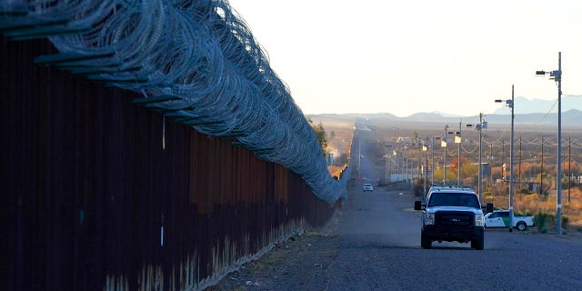 A U.S. Border Patrol vehicle drives along the border fence at the U.S.-Mexico border wall, on Dec. 15, 2020, in Douglas, Ariz.