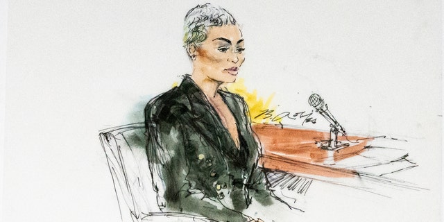 In this courtroom artist sketch, former reality television star Blac Chyna sits in court in Los Angeles, Tuesday, April 19, 2022.  The Kardashian-Jenner family have won in the defamation lawsuit brought against them by Blac Chyna.