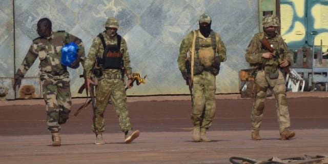 This undated photograph handed out by the French military shows three Russian mercenaries, right, in northern Mali.