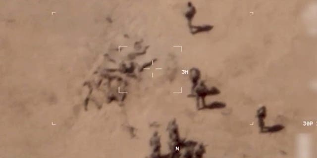 This image taken from a video shows soldiers burying bodies near an army base in northern Mali. The French military says it has videos of Russian mercenaries burying bodies near an army base in northern Mali. 