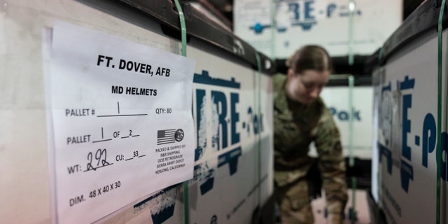 U.S. Air Force Airman Megan Konsmo, from Tacoma, Wash., checks pallets of helmets ultimately bound for Ukraine in the Super Port of the 436th Aerial Port Squadron, Friday, April 29, 2022, at Dover Air Force Base, Del.