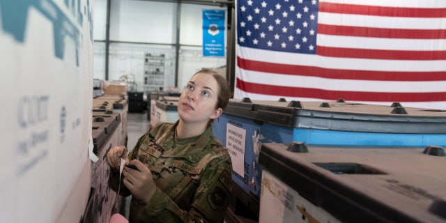 U.S. Air Force Airman Megan Konsmo, from Tacoma, Wash., checks pallets of equipment ultimately bound for Ukraine in the Super Port of the 436th Aerial Port Squadron, Friday, April 29, 2022, at Dover Air Force Base, Del.
