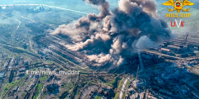 Smoke rises from the Metallurgical Combine Azovstal in Mariupol, in territory under the government of the Donetsk People's Republic, eastern Ukraine, on May 4, 2022.