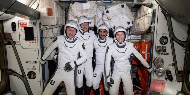 In this photo made available by NASA, four commercial crew astronauts, from left, European Space Agency astronaut Matthias Maurer and NASA astronauts Tom Marshburn, Raja Chari and Kayla Barron pose for a photo in their Dragon spacesuits during a fit check aboard the International Space Station's Harmony module on April 21, 2022.