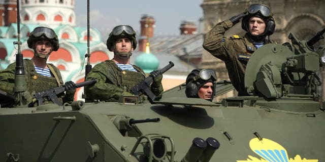 Russian Army soldiers stand in a military vehicle rolling during a dress rehearsal for the Victory Day military parade in Moscow, Russia, Saturday, May 7, 2022. The parade will take place at Moscow's Red Square on May 9 to celebrate 77 years of the victory in WWII.