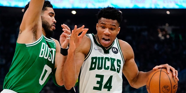 Milwaukee Bucks' Giannis Antetokounmpo gets past Boston Celtics' Jayson Tatum during the first half of Game 3 of an NBA basketball Eastern Conference semifinals playoff series Saturday, May 7, 2022, in Milwaukee. 