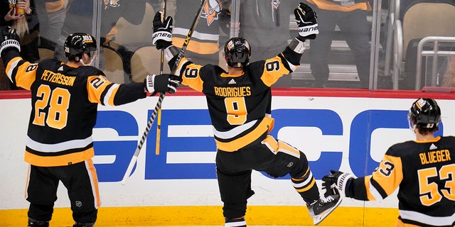 Pittsburgh Penguins' Evan Rodrigues (9) celebrates his second goal of the first period in Game 3 of an NHL hockey Stanley Cup first-round playoff series against the New York Rangers in Pittsburgh, Saturday, May 7, 2022.