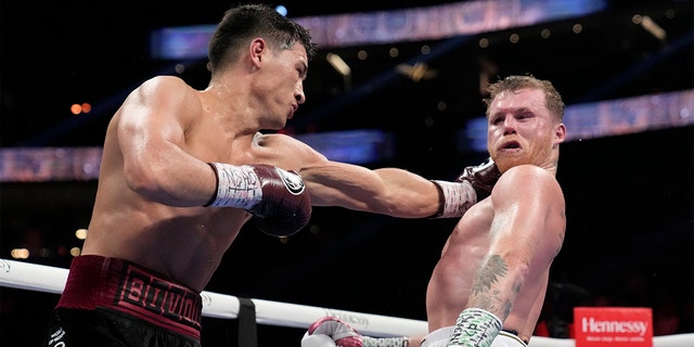 Kyrgyzstan's left-hander Dimitri Bevel throws a fist at Mexico's Canelo Alvarez during a light heavyweight title fight in Las Vegas on Saturday, May 7, 2022.