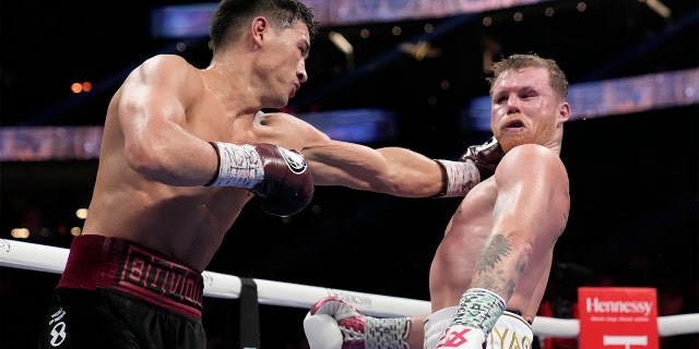 Dmitry Bivol, left, of Kyrgyzstan, throws a punch against Canelo Alvarez of Mexico during a light heavyweight title fight Saturday, May 7, 2022, in Las Vegas.