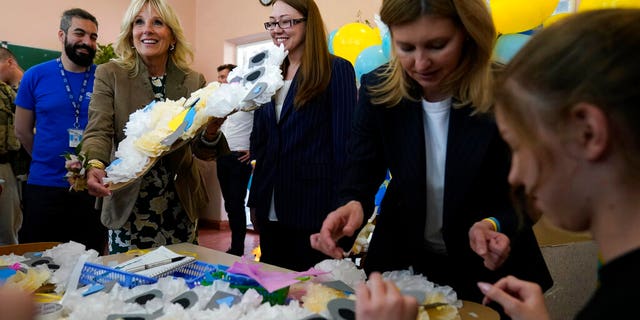 First Lady Jill Biden, second left, and Olena Zelenska, spouse of Ukrainian's President Volodymyr Zelenskyy, join a group of children at School 6 in making tissue-paper bears to give as Mother's Day gifts in Uzhhorod, Ukraine, Sunday, May 8, 2022.