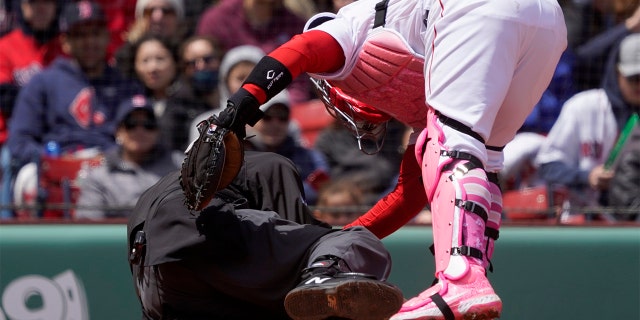 Boston Red Sox catcher Christian Vazquez checks on home plate umpire Ron Kulpa after Kulpa was hit with a foul ball during the fourth inning a game between the Boston Red Sox and the Chicago White Sox at Fenway Park, Sunday, May 8, 2022, in Boston.