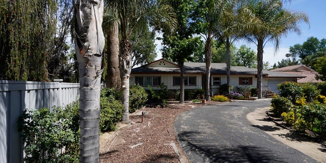 A ranch-style house in the West Hills neighborhood of the San Fernando Valley is seen in Los Angeles. Police say three children were found dead inside over the weekend and their mother and a teenager were arrested in the killings.