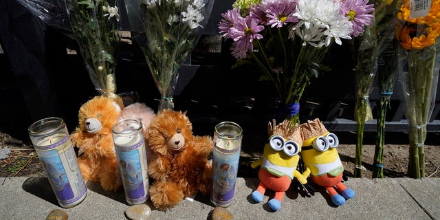 Flowers and teddy bears are left outside a ranch-style house in the West Hills neighborhood of the San Fernando Valley where three children were found dead on Mother's Day. 