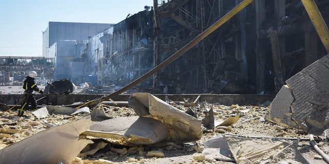 An Ukrainian firefighter works near a destroyed building on the outskirts of Odesa, Ukraine, Tuesday, May 10, 2022. The Ukrainian military said Russian forces fired seven missiles a day earlier from the air at the crucial Black Sea port of Odesa, hitting a shopping center and a warehouse.  