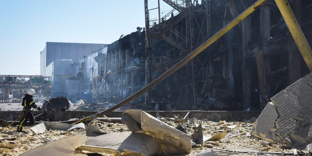 A Ukrainian firefighter works near a destroyed building on the outskirts of Odesa, Ukraine on Tuesday 10 May 2022. The Ukrainian military said Russian forces fired seven missiles a day earlier from the air into the crucial Odesa seaport. Black hitting a downtown shop and warehouse.