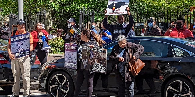 Demonstrators stand outside Manhattan federal court to protest former Honduran President Juan Orlando Hernandez who appeared in court on drug trafficking and weapons charges, Tuesday, May 10, 2022, in New York. 