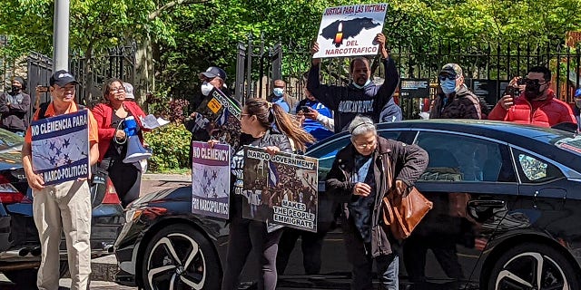 Demonstrators stand outside Manhattan federal court to protest former Honduran President Juan Orlando Hernandez who appeared in court on drug trafficking and weapons charges, Tuesday, May 10, 2022, in New York.