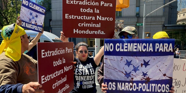 Demonstrators stand outside Manhattan federal court to protest former Honduran President Juan Orlando Hernandez, who pleaded not guilty to charges that he received millions of dollars from 2004 to 2022 to support a drug trade that delivered hundreds of thousands of kilos of drugs to the U.S., Tuesday, May 10, 2022, in New York.