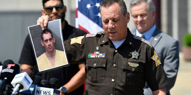 Vandenburgh County Sheriff Dave Wedding holds up a photo of captured Alabama escapee Casey White during a press conference at the Vandenburgh County Sheriff's Office in Evansville, In., Tuesday, May 10, 2022.