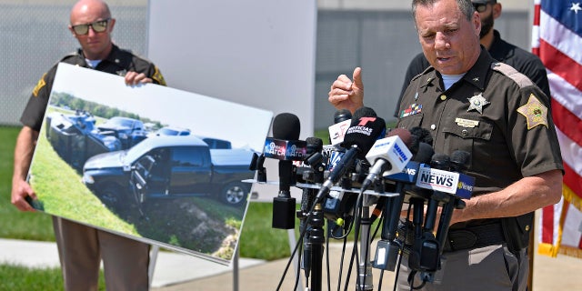 Vanderburgh County Sheriff Dave Wedding shows a photograph of the Ford F-150 truck that escaped fugitives Casey White and Vicky White were in when they were captured during a press conference in Evansville, Ind., Tuesday, May 10, 2022.