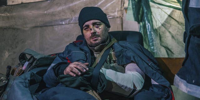 In this photo provided by Azov Special Forces Regiment of the Ukrainian National Guard Press Office, an Azov Special Forces Regiment's serviceman, injured during fighting against Russian forces, poses for a photographer inside the Azovstal steel plant in Mariupol, Ukraine, Tuesday, May 10, 2022. 