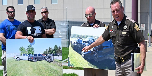 Vandenburgh County Sheriff Dave Wedding, right, refers to a photograph during a press conference in Evansville, In., Tuesday, May 10, 2022, about the capture of fugitives Casey White and Vicky White. 