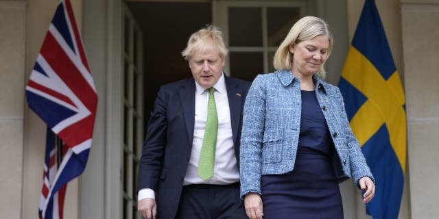 British Prime Minister Boris Johnson, left, and Sweden's Prime Minister Magdalena Andersson arrive for a joint press conference in Harpsund, the country retreat of Swedish prime ministers, Wednesday, May 11, 2022. 