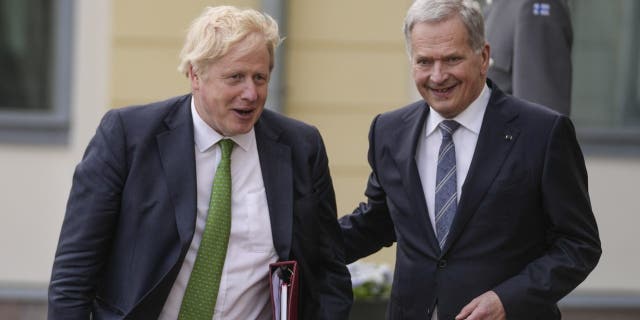 British Prime Minister Boris Johnson, left, and Finland's President Sauli Niinisto, arrive at the Presidential Palace for talks, in Helsinki, Finland, Wednesday, May 11, 2022.