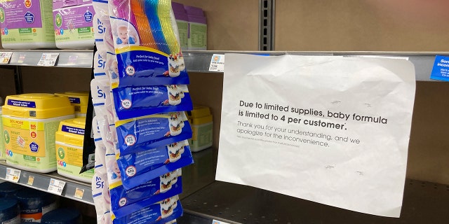 A sign telling consumers of limits on the purchase of baby formula hangs on the edge of an empty shelf for the product in a King Soopers grocery store, on May 11, 2022, in southeast Denver.  Parents across the country have been struggling to find baby formula in stock in stores.