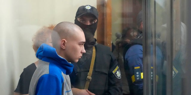 Russian army Sergeant Vadim Shishimarin, 21, is seen behind a glass during a court hearing in Kyiv, Ukraine, Friday, May 13, 2022. The trial of a Russian soldier accused of killing a Ukrainian civilian opened Friday, the first war crimes trial since Moscow's invasion of its neighbor. (G3 Box News Photo/Efrem Lukatsky)