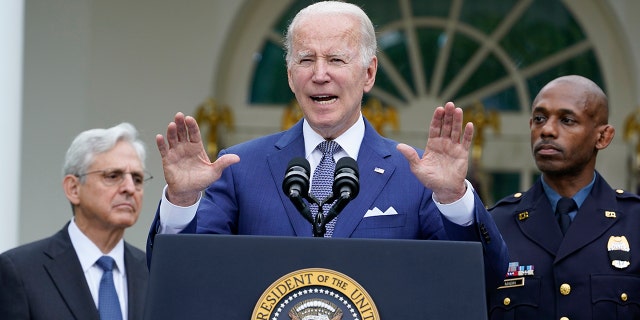 President Joe Biden speaks in the Rose Garden of the White House in Washington, Friday, May 13, 2022, during an event to highlight state and local leaders who are investing American Rescue Plan funding. Attorney General Merrick Garland, left, and Kansas City, Mo., Police Department Police Chief Joe Mabin listen. (AP Photo/Susan Walsh)