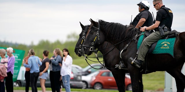 FILE -Officers on horseback guard the entrance to designated demonstrator areas near Riverbend Maximum Security Institution as people wait to enter before the scheduled execution of inmate Oscar Smith, Thursday, April 21, 2022, in Nashville, Tenn. (AP Photo/Mark Humphrey, File)