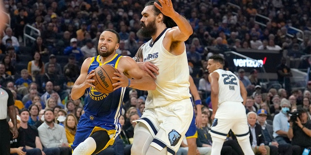 Golden State Warriors guard Stephen Curry drives to the basket against Memphis Grizzlies center Steven Adams during the first half of Game 6 of an NBA basketball Western Conference playoff semifinal in San Francisco, Friday, May 13, 2022. 