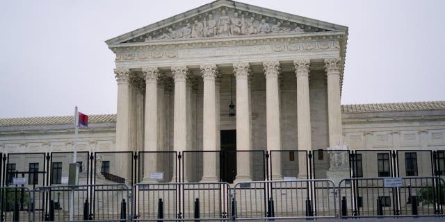 Security fencing is in place outside the Supreme Court in Washington, Saturday, May 14, 2022.