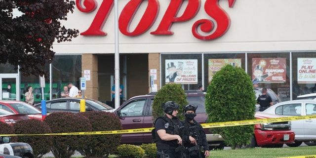 Police secure an area around a supermarket where several people were killed in a shooting, Saturday, May 14, 2022 in Buffalo, N.Y. Officials said the gunman entered the supermarket with a rifle and opened fire. Investigators believe the man may have been livestreaming the shooting and were looking into whether he had posted a manifesto online (Derek Gee/The Buffalo News via AP)