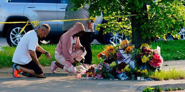 People pay their respects outside the scene of a shooting at a supermarket in Buffalo, N.Y., Sunday, May 15, 2022. 