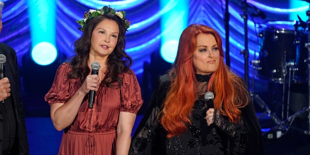 Ashley Judd, left, and Wynonna Judd speak during a tribute to their mother, country music star Naomi Judd, Sunday, May 15, 2022, in Nashville, Tenn.  Naomi Judd died on April 30.  She was 76 years old.  (AP Photo/Mark Humphrey)