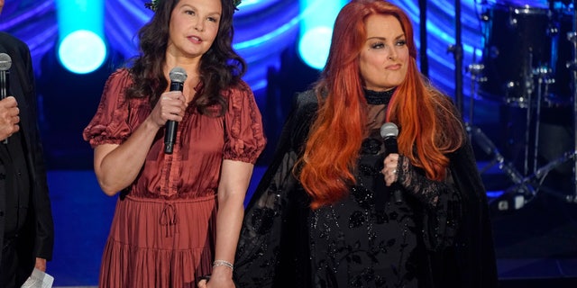 Ashley Judd, left, and Wynonna Judd speak during a tribute to their mother, country music star Naomi Judd, Sunday, May 15, 2022, in Nashville, Tenn. Naomi Judd died April 30. She was 76. (AP Photo/Mark Humphrey)