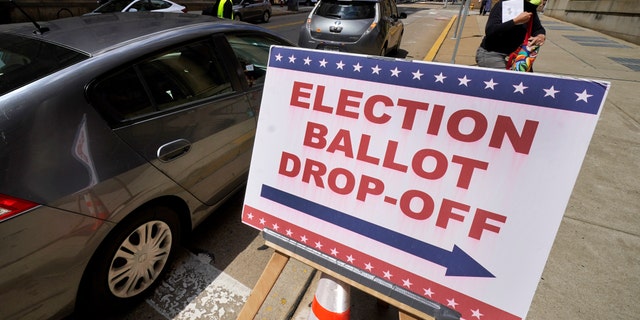 A voter arrives to cast their mail-in ballot at the City-County Building in downtown Pittsburgh Monday, May 16, 2022. (AP Photo/Gene J. Puskar)