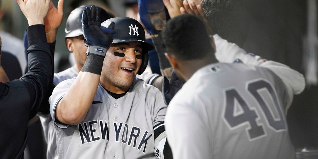 New York Yankees' Jose Trevino, left, celebrates his three-run home run with teammate Luis Severino (40) and others in the dugout during the fourth inning of a baseball game against the Baltimore Orioles, Monday, May 16, 2022, in Baltimore.