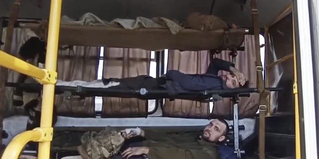 In this photo taken from video released by the Russian Defense Ministry Press Service on Tuesday, May 17, 2022, wounded Ukrainian servicemen lay in a bus as they are being evacuated from the besieged Azovstal steel plant in Mariupol, Ukraine. 