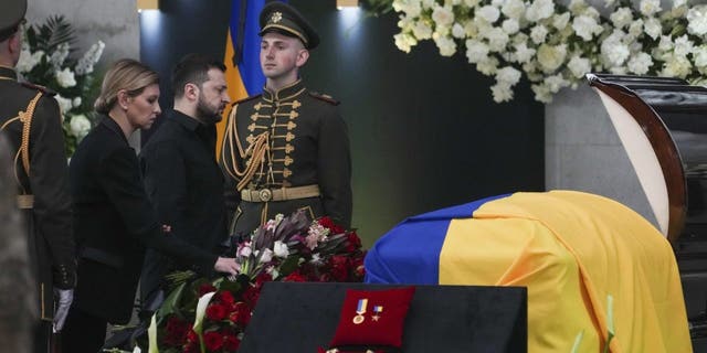 Ukrainian President Volodymyr Zelenskyy, center left, and his wife Olena Zelenska pay their respects at the funeral of Leonid Kravchuk, independent Ukraine's first president, during a farewell ceremony.