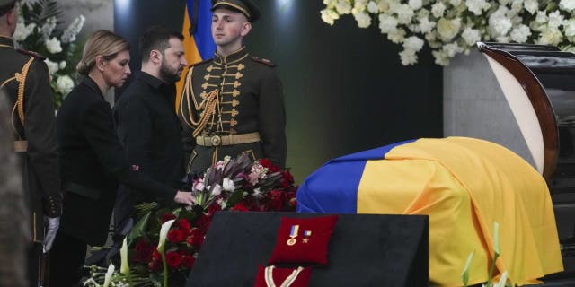 Ukrainian President Volodymyr Zelenskyy, center left, and his wife Olena Zelenska pay their respects at the funeral of Leonid Kravchuk, independent Ukraine's first president, during a farewell ceremony.