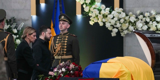 Ukrainian President Volodymyr Zelenskyy, center left, and his wife Olena Zelenska pay their respects at the funeral of Leonid Kravchuk, independent Ukraine's first president, during a farewell ceremony at the International Convention Center Ukrainian House, in Kyiv, Ukraine, Tuesday, May 17, 2022.