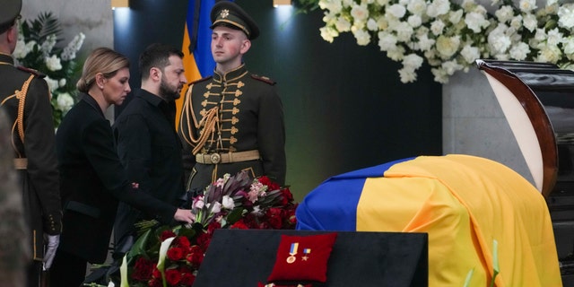 Ukrainian President Volodymyr Zelenskyy, center left, and his wife Olena Zelenska pay their respects at the funeral of Leonid Kravchuk, independent Ukraine's first president, during a farewell ceremony at the International Convention Center Ukrainian House, in Kyiv, Ukraine, Tuesday, May 17, 2022.