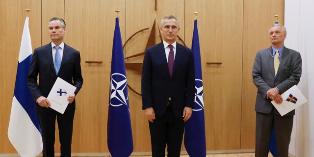 Finland's Ambassador to NATO Klaus Korhonen, left, NATO Secretary-General Jens Stoltenberg and Sweden's Ambassador to NATO Axel Wernhoff attend a ceremony to mark Sweden's and Finland's application for membership in Brussels, Belgium, Wednesday, May 18, 2022.