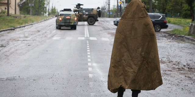 A serviceman of Donetsk People's Republic militia stands guard not far from the besieged Mariupol's Azovstal steel plant in Mariupol, in territory under the government of the Donetsk People's Republic, eastern Ukraine, Wednesday, May 18, 2022. 