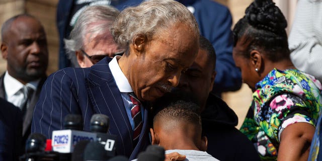 The Rev., Al Sharpton hugs Jaques "Jake" Patterson, 12, son of Buffalo shooting victim Heyward Patterson, during a press conference outside the Antioch Baptist Church on Thursday, May 19, 2022, in Buffalo, N.Y. 